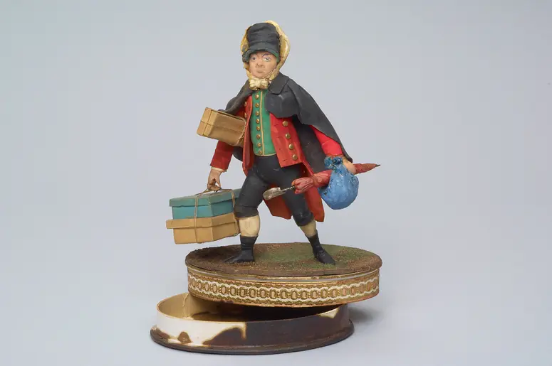 Carl Carl als Staberl - Tragantfigur, Verweis auf Stücktitel: Staberls Reise-Abenteuer
